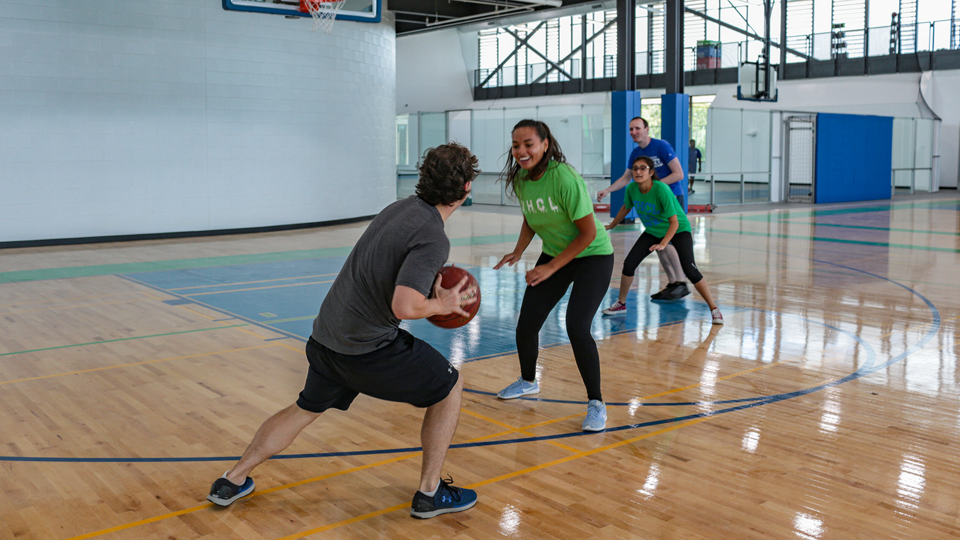 Students playing basketball on the indoor athletic courts