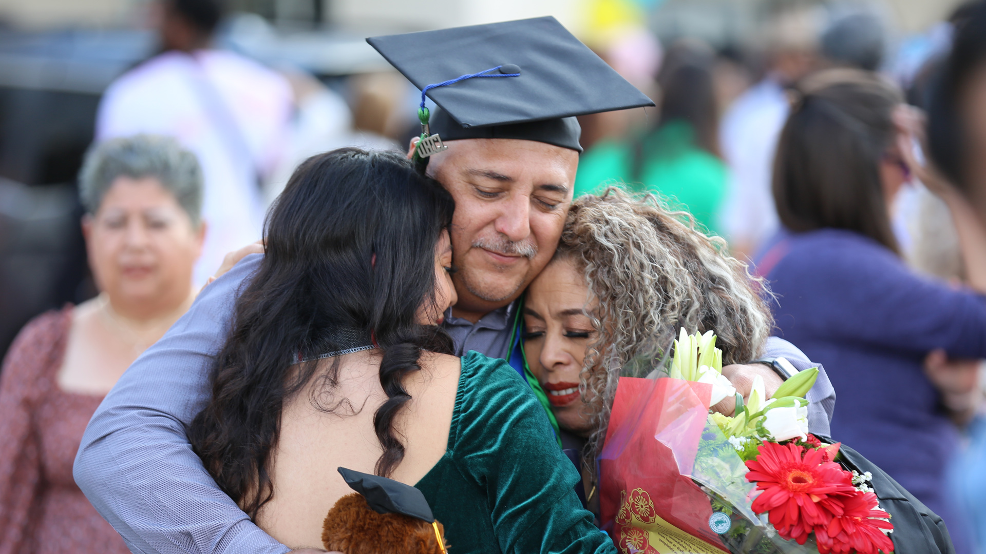 New graduate celebrating with family after the ceremony