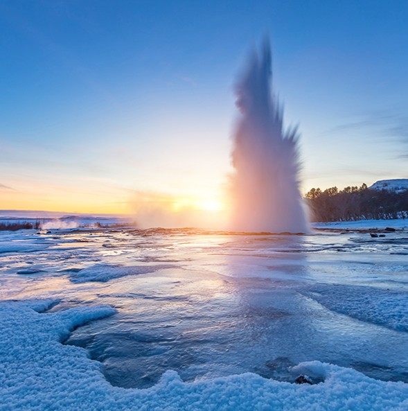 A geyser shoots up into the cold iceland air