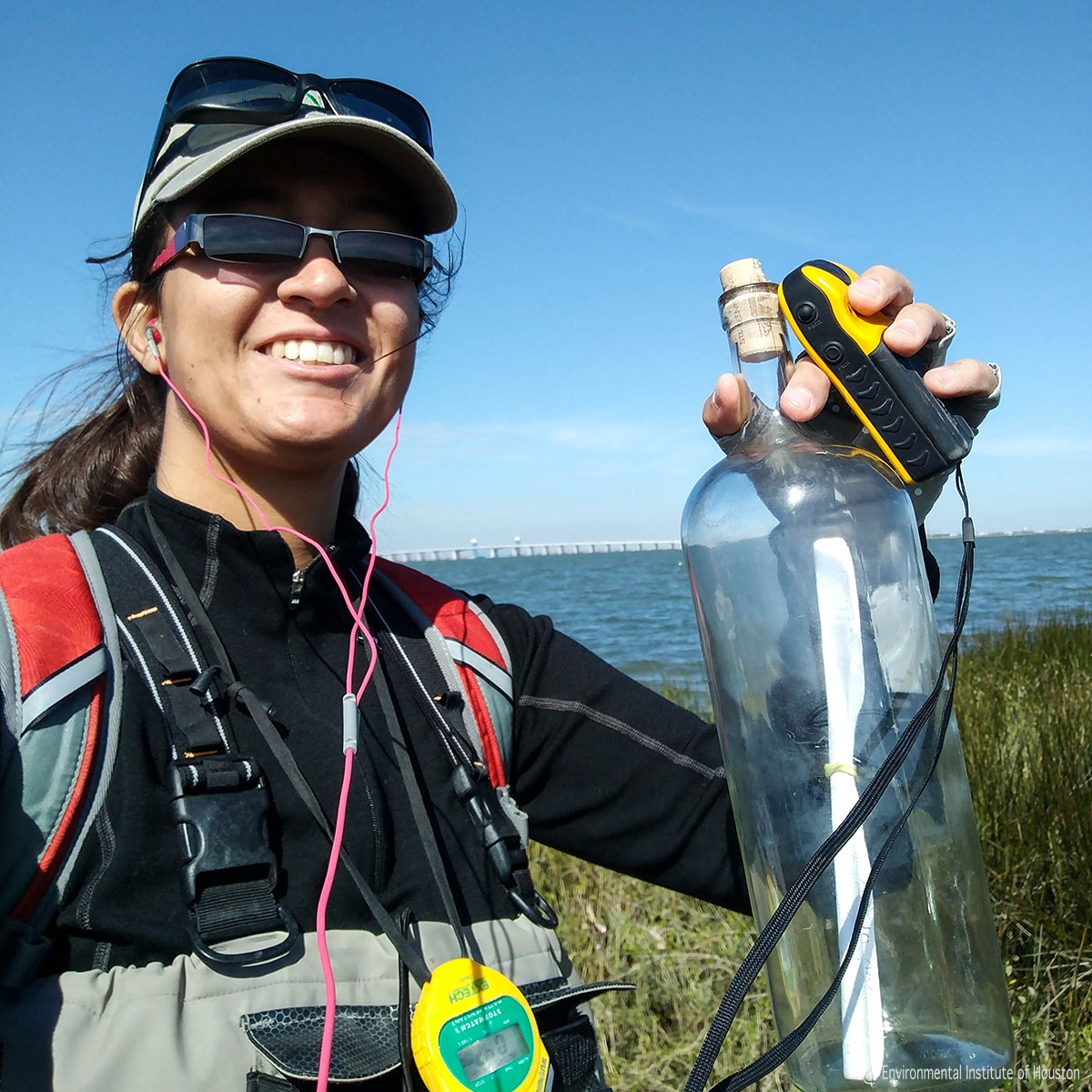 Nicole Morris retrieves a glass bottle found in a marsh on Galveston Island
