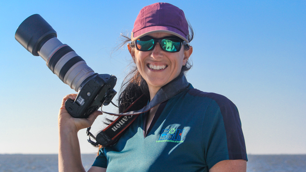 Kristi Fazioli Kristi is holding a camera with a zoom lens.