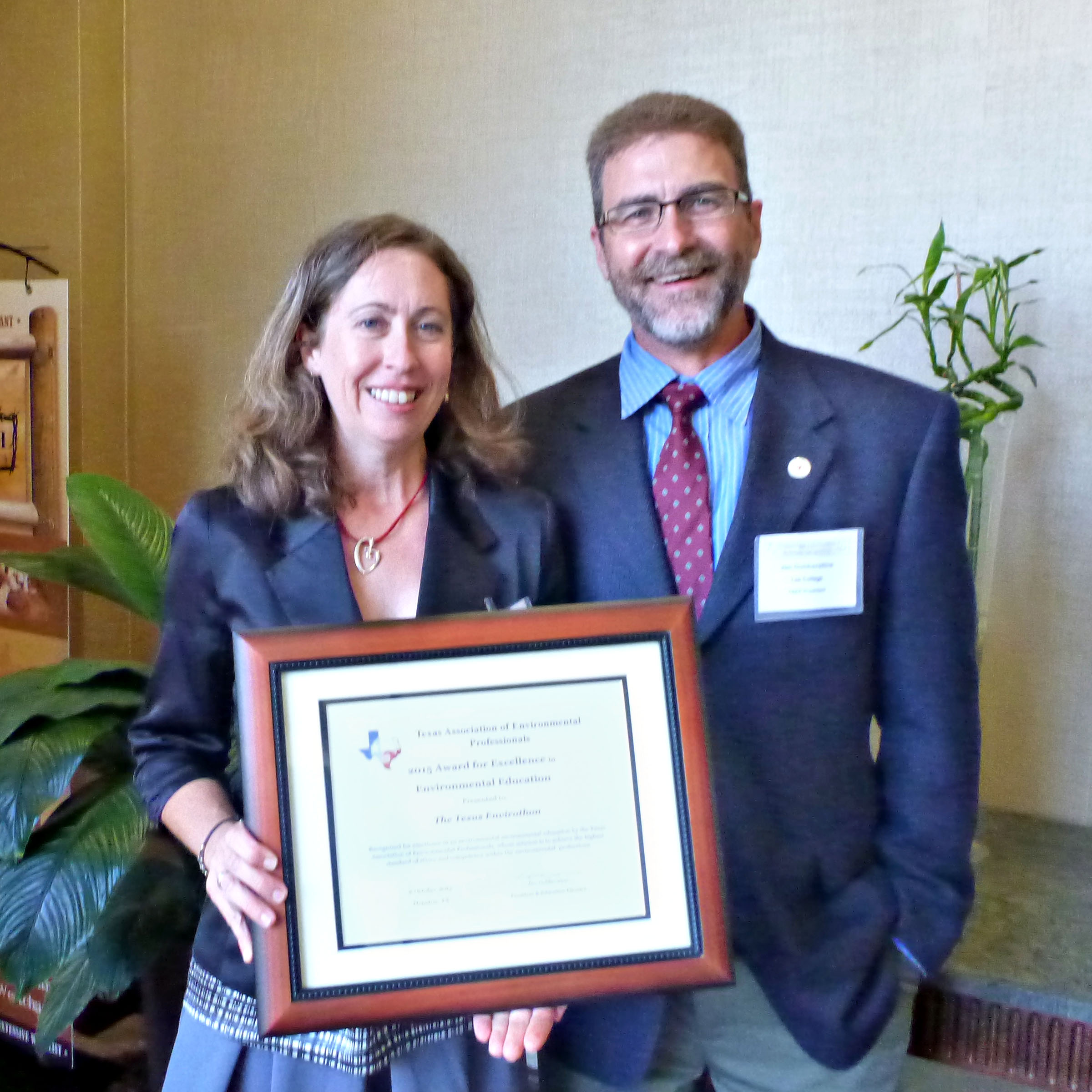 Wendy Reistle and Jim Dobberstine hold a framed certificate