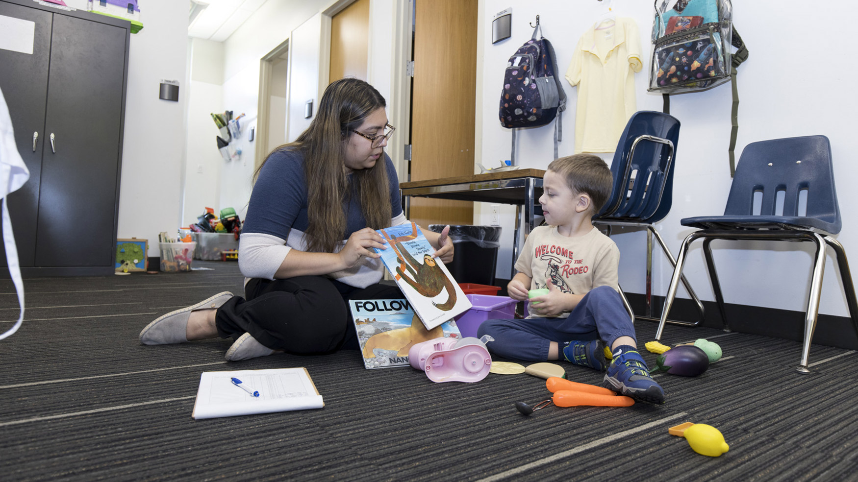 Image of therapist with small child during session