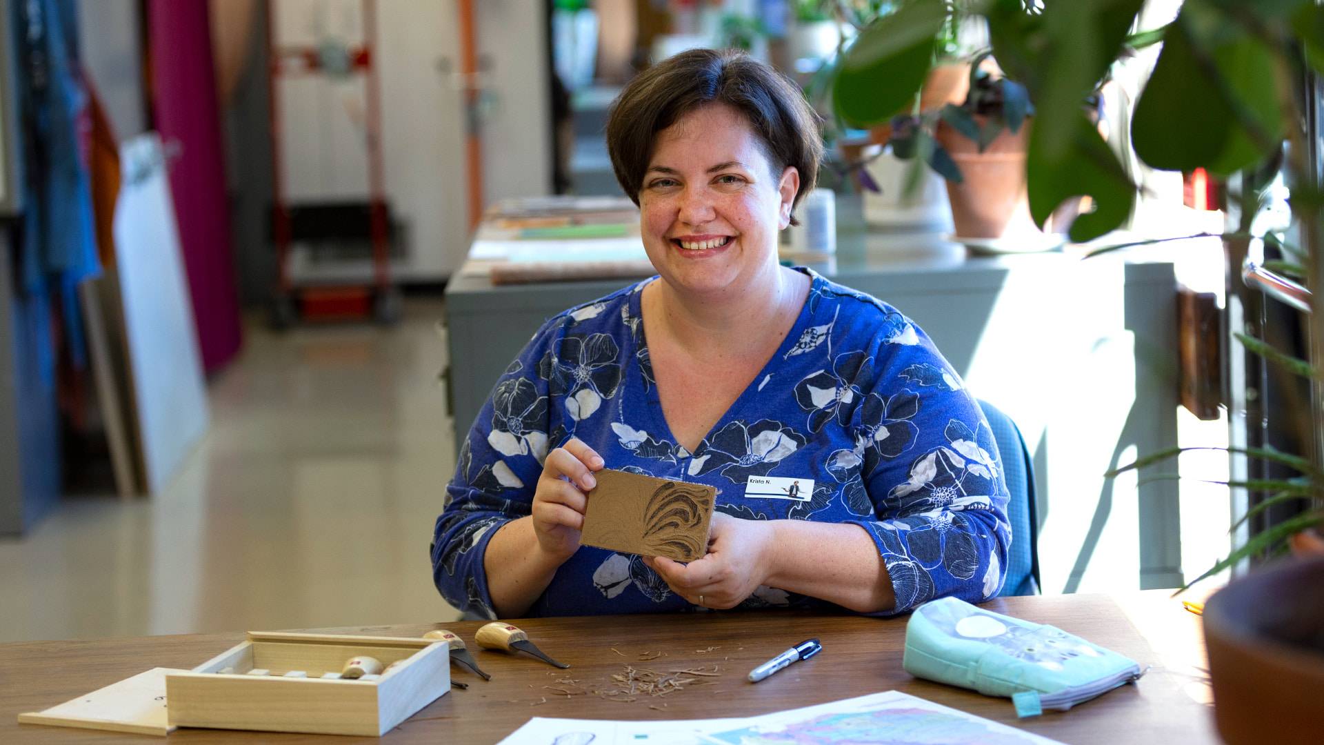 An art educator demonstrating an art project.