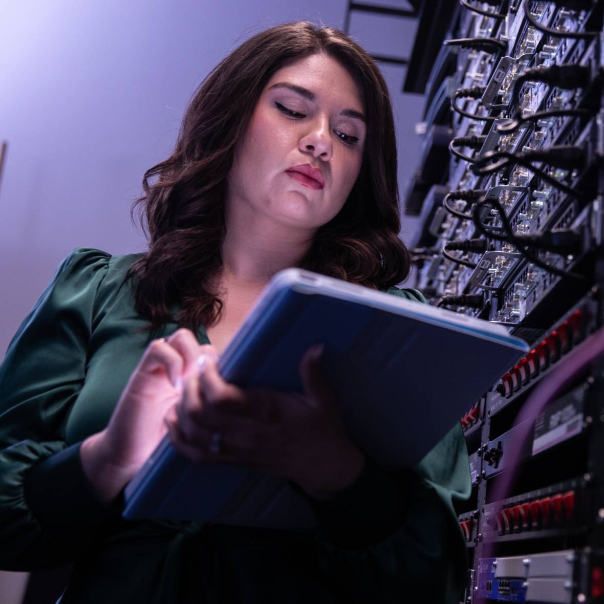 UHCL Student on tablet in a server room