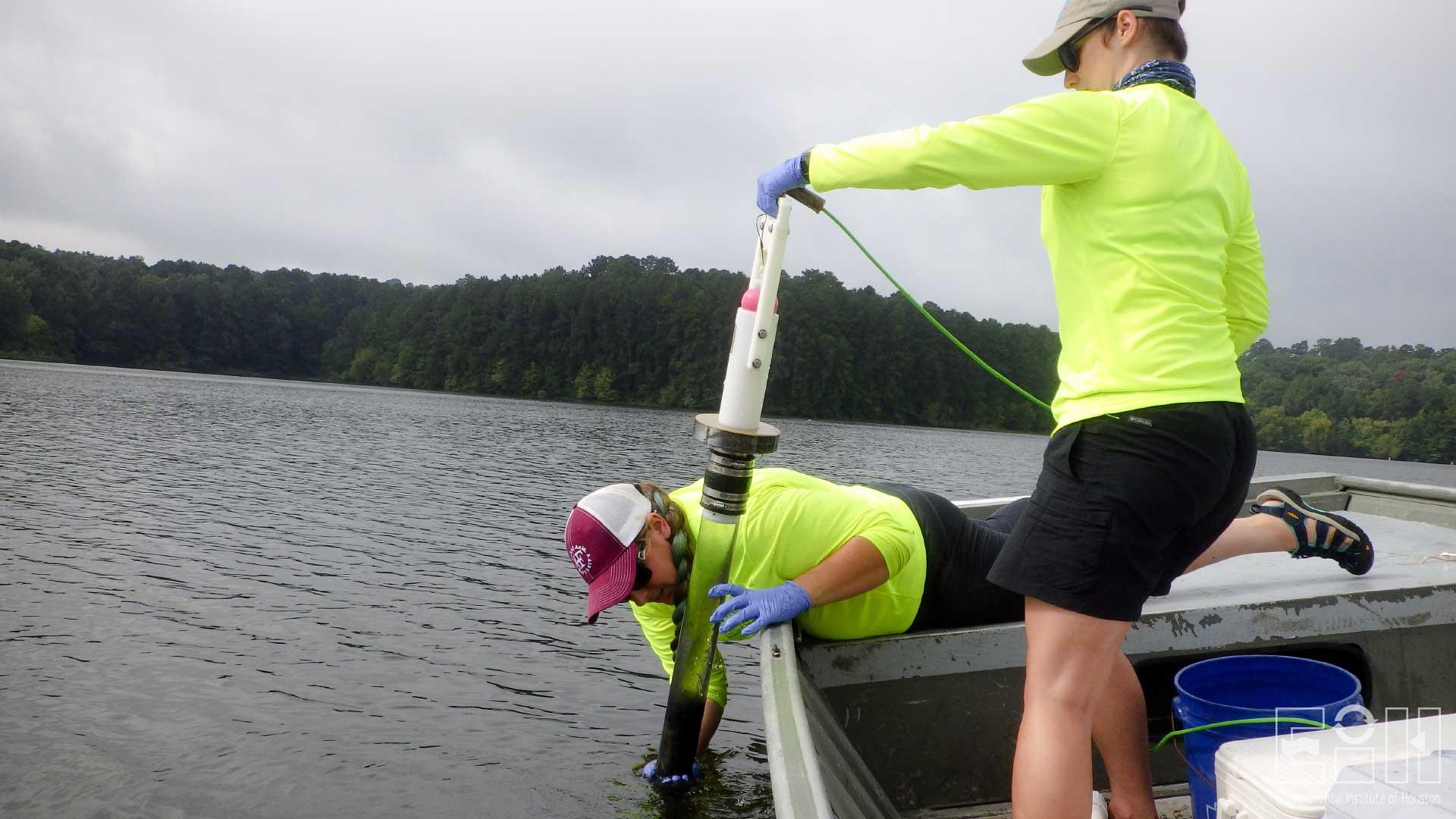 Jo Vaughn and Emily Miller, lentic ecology technicians, take a core sample in Pinkston Reservoir.