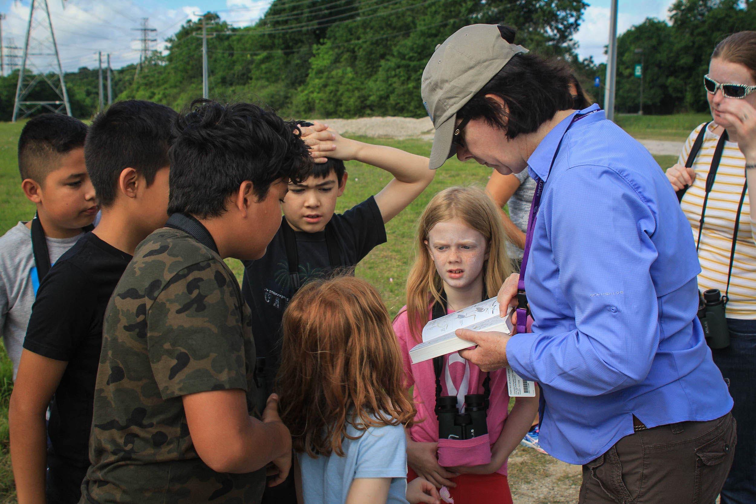 Rowena McDermid explains the use of a bird field guide