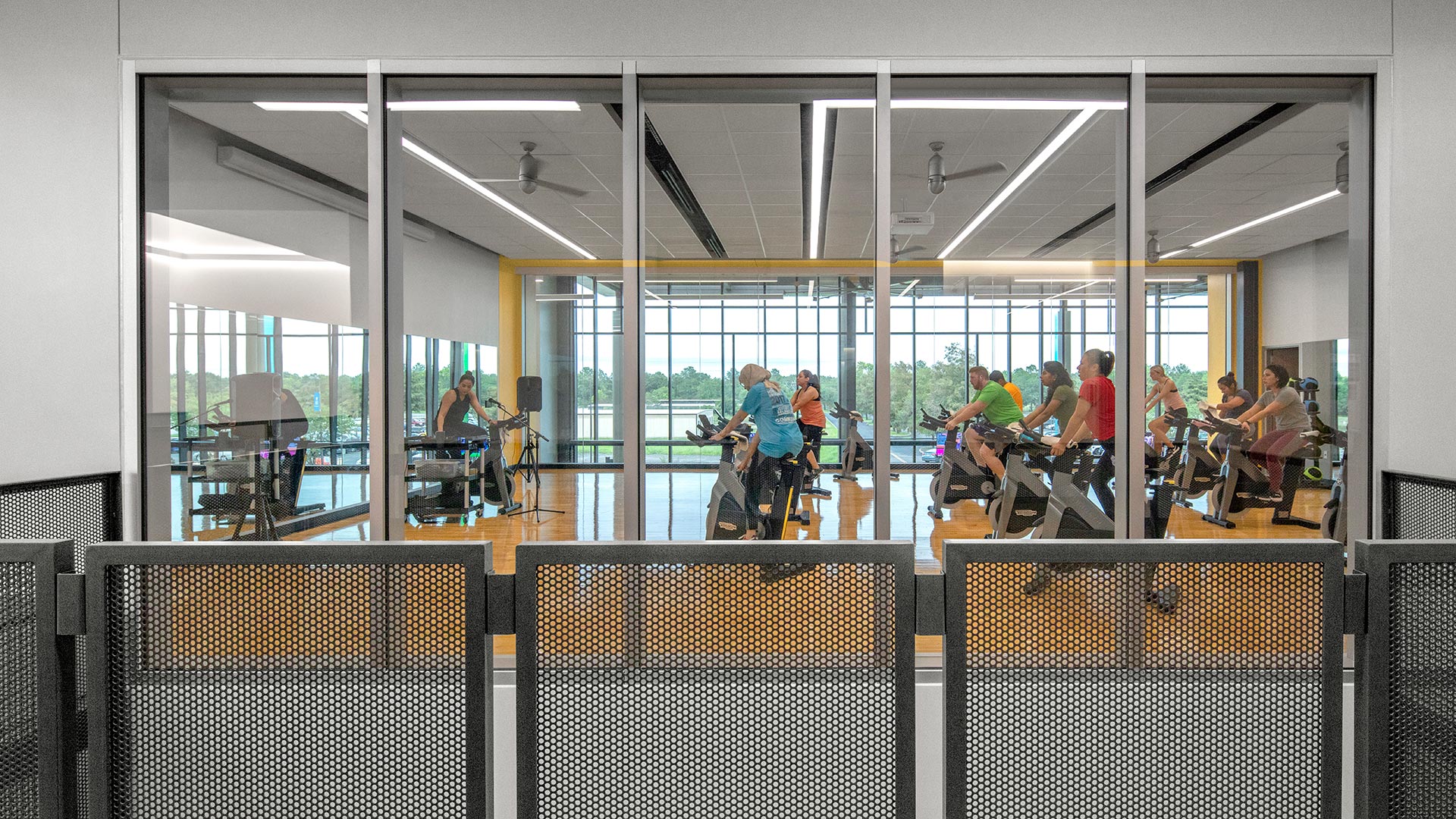 Students in a group fitness class with stationary bikes