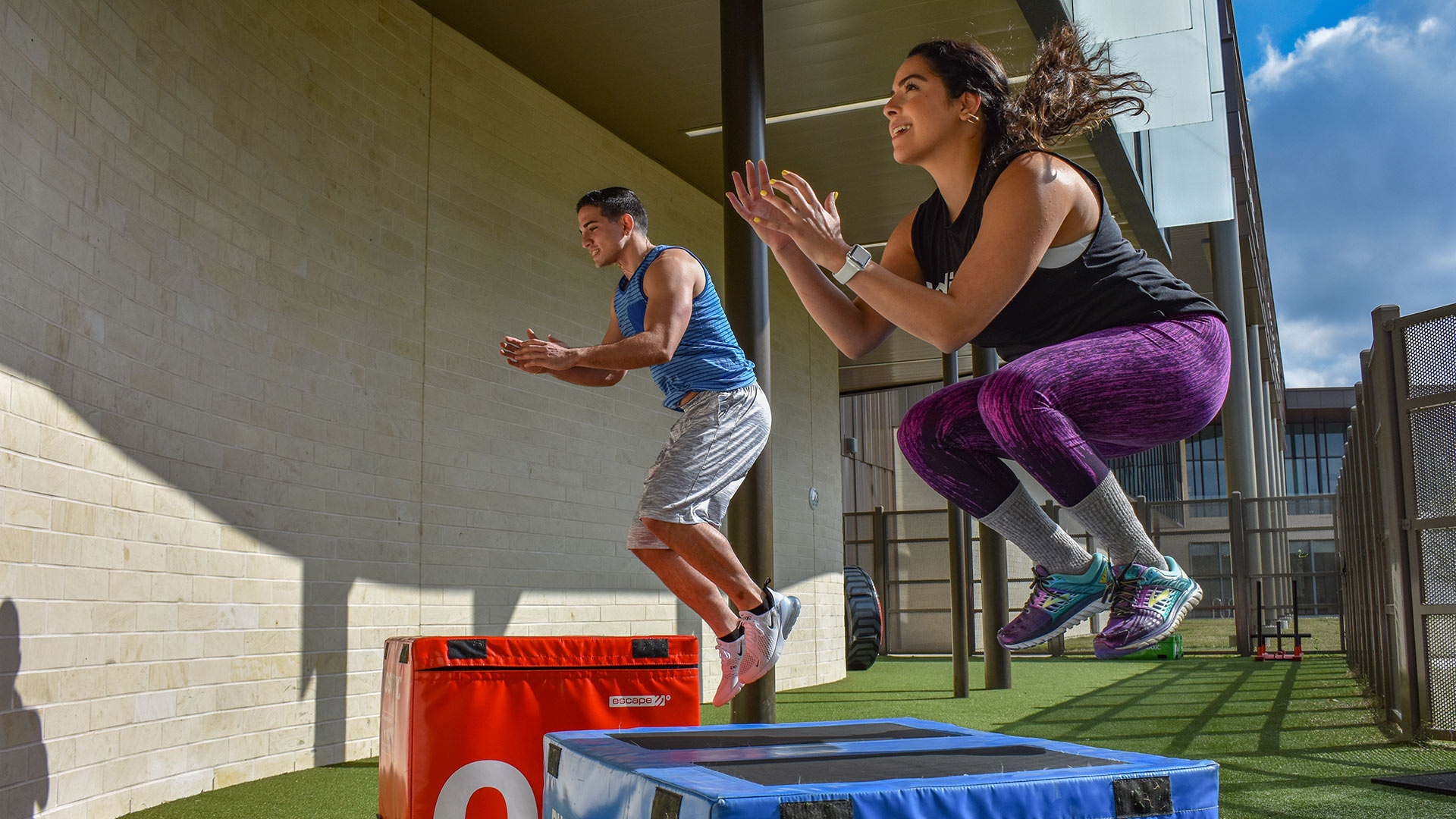 Members exercising in the Recreation and Wellness Center backyard