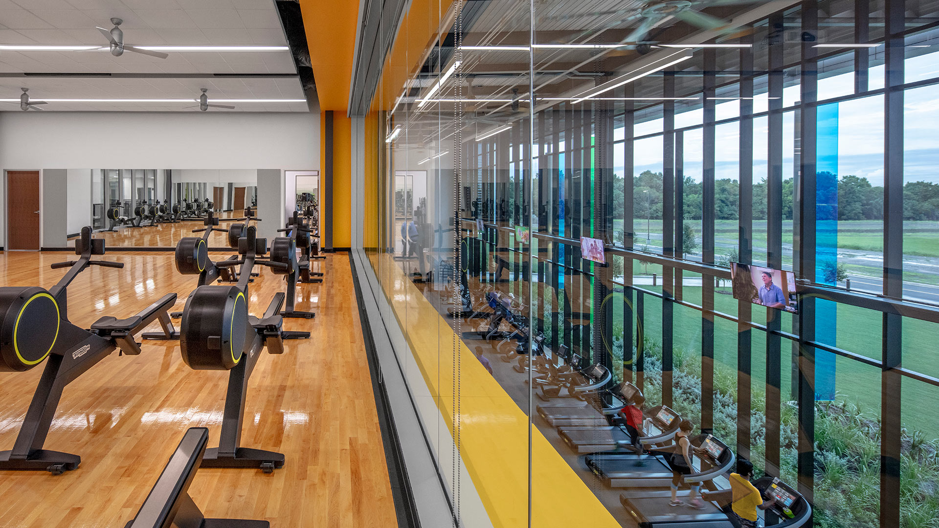 View of the multi-purpose room with stationary bikes and treadmills in the fitness zone below