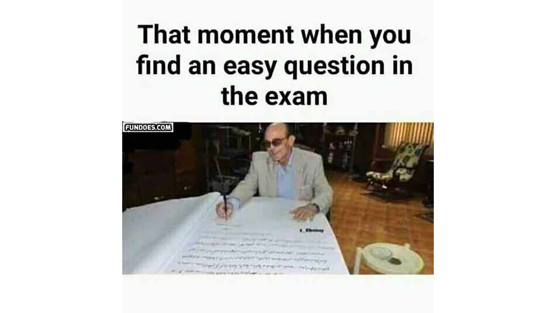 Image Title: That moment when you find an easy question in the exam. A man writes into a large notebook.