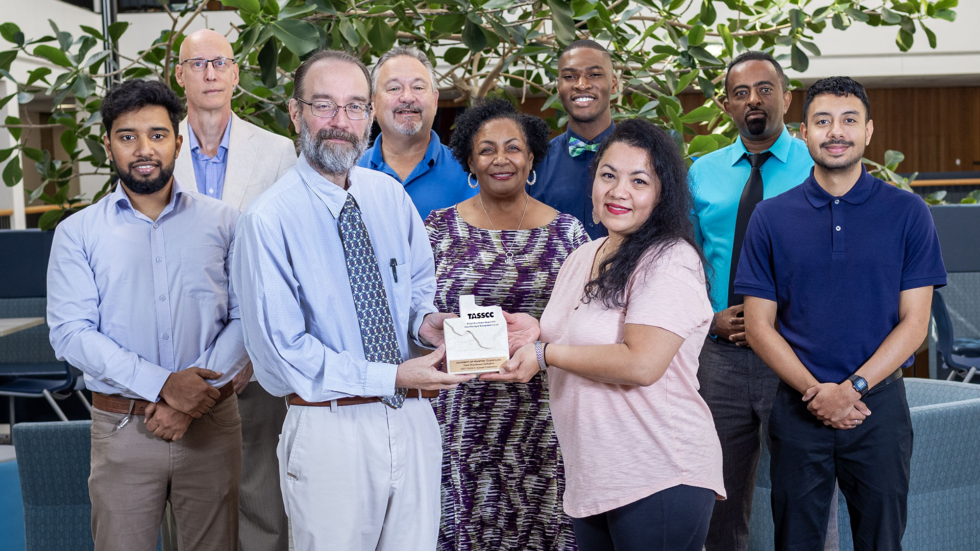 Staff members holding award