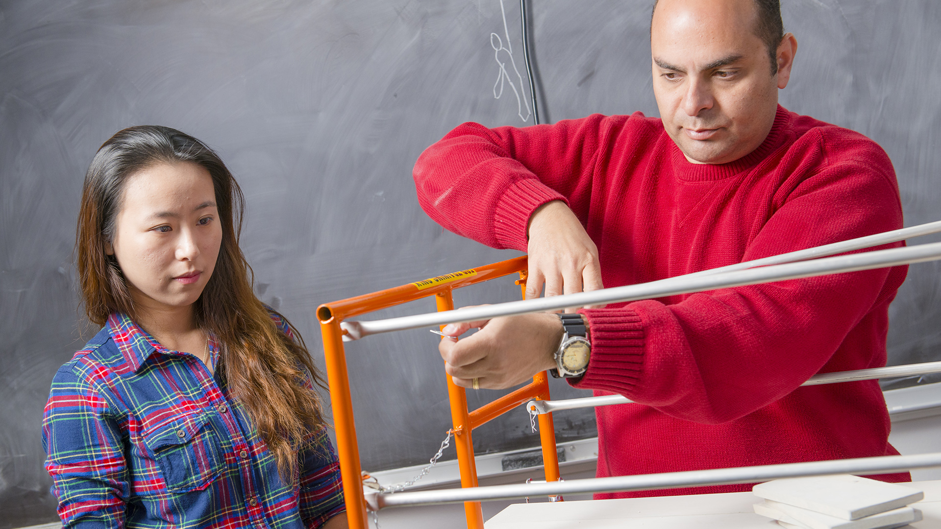 Photo of Dr. Akladios and a UHCL student working in the lab