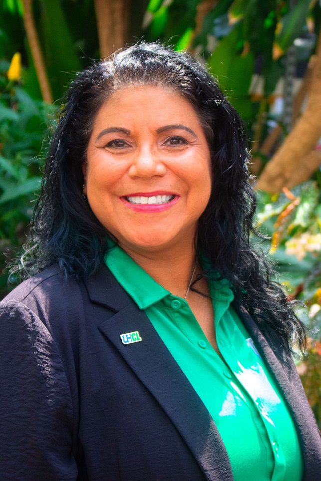 Portrait photograph of Cynthia Parra wearing a green polo with black blazer.