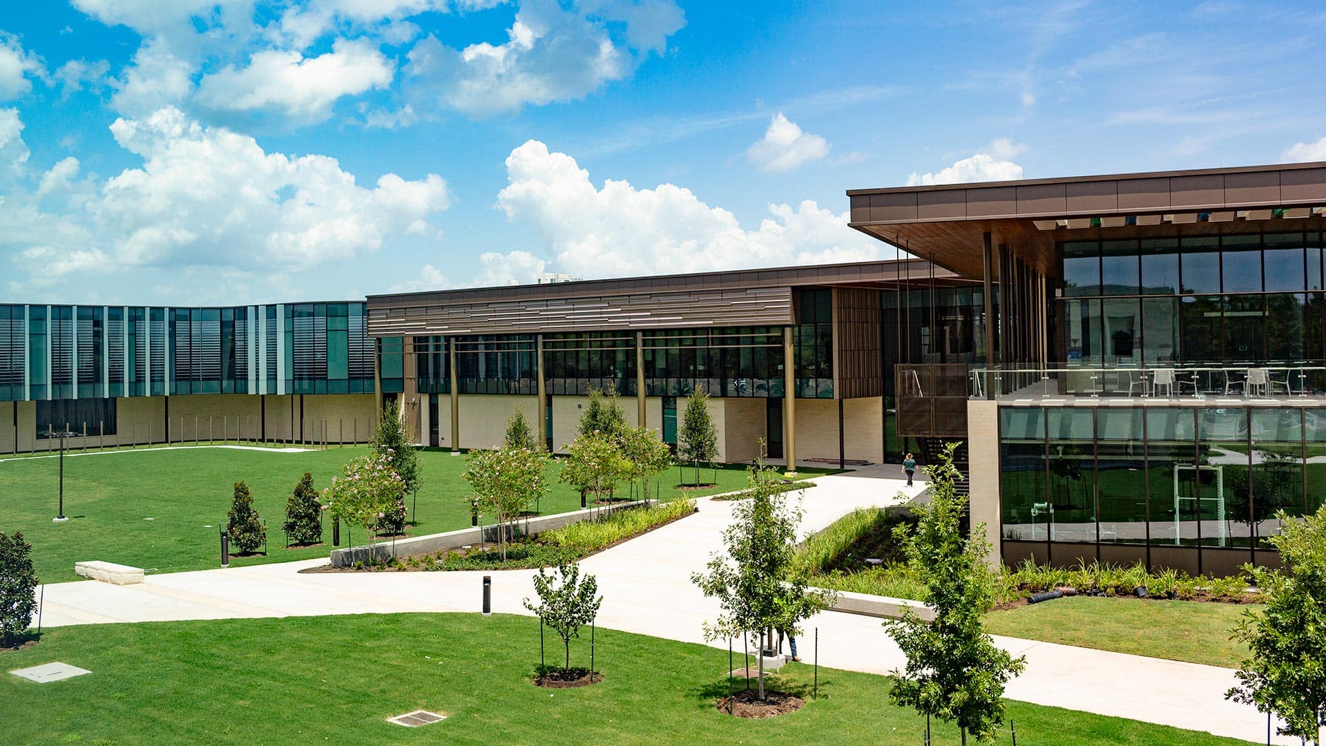 The UHCL Recreation and Wellness Center with green lawns