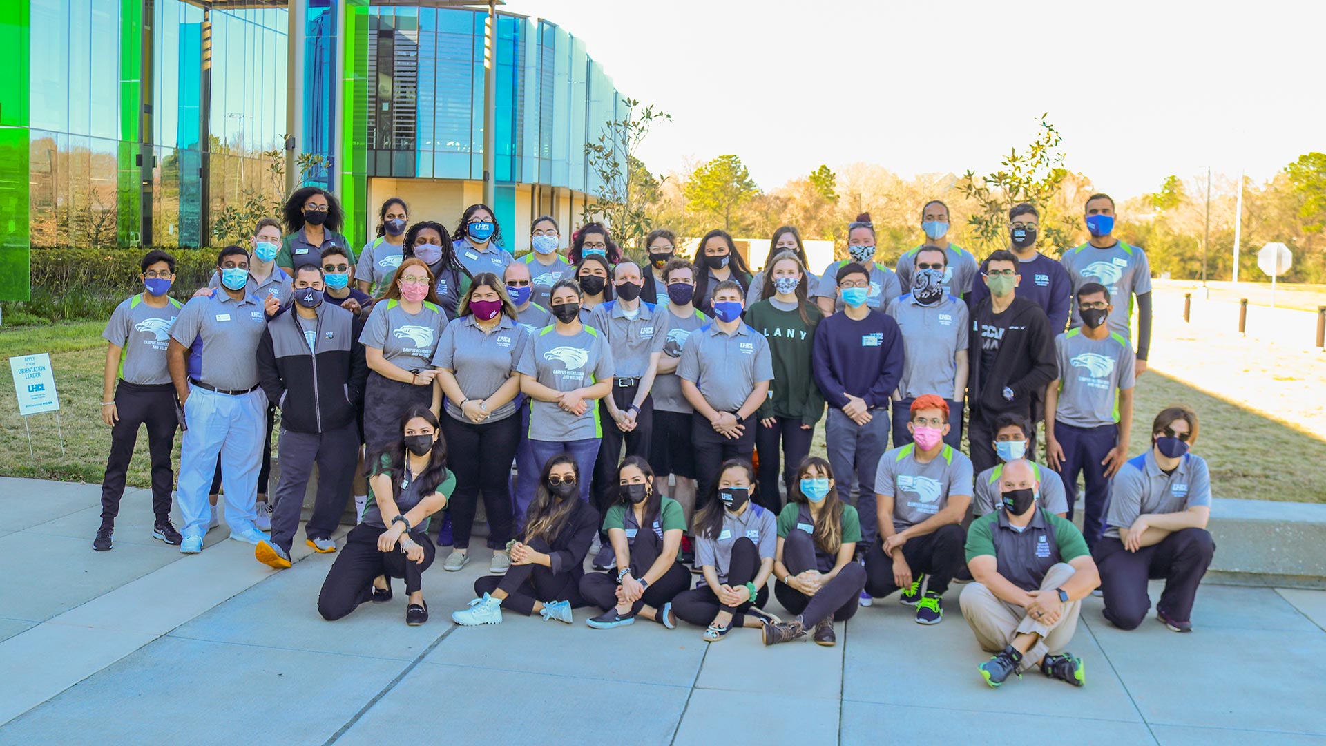 Recreation and Wellness Center staff, masked, outside the main building.