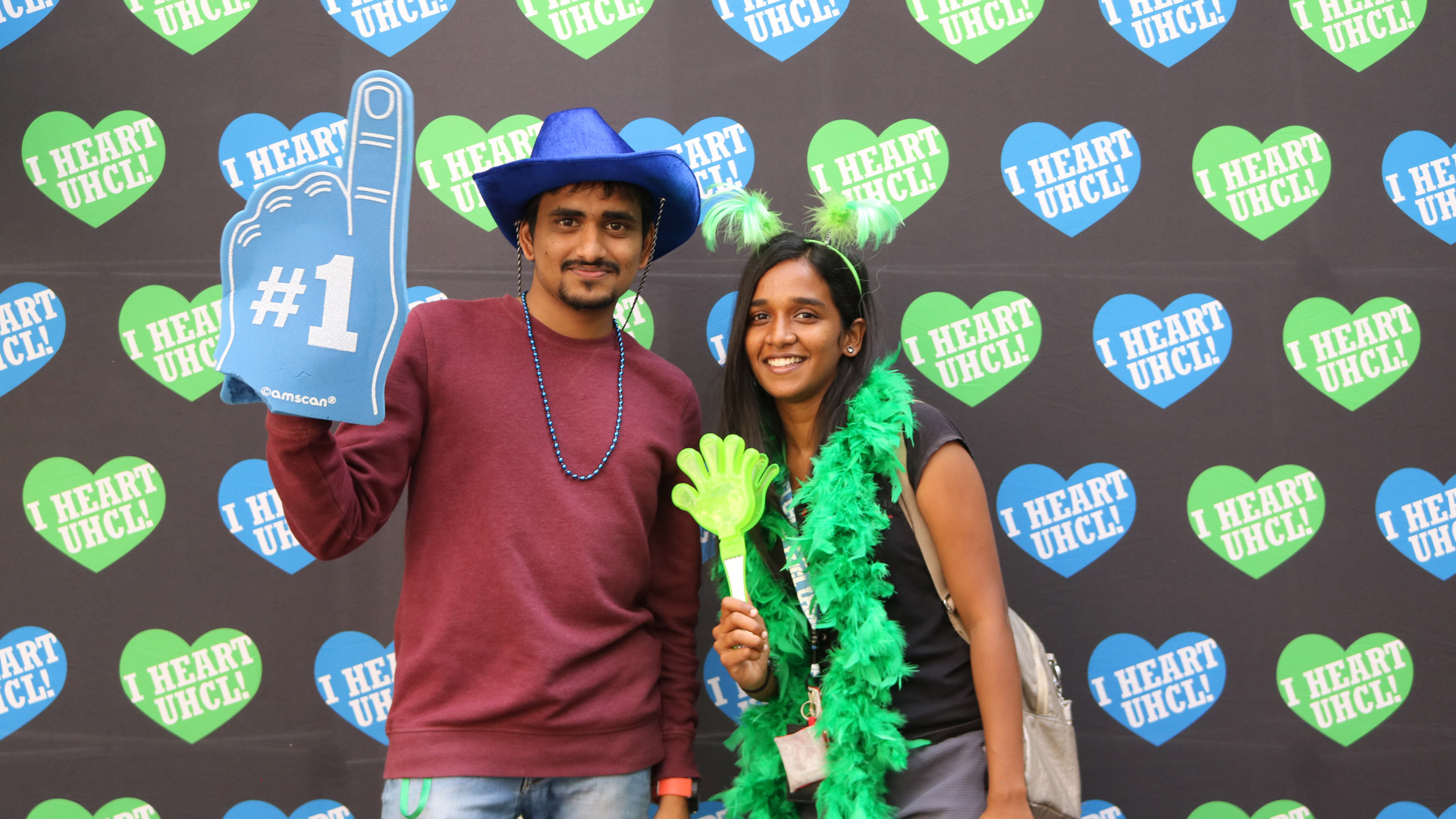 Students wearing hats and #1 signs with I Heart UHCL