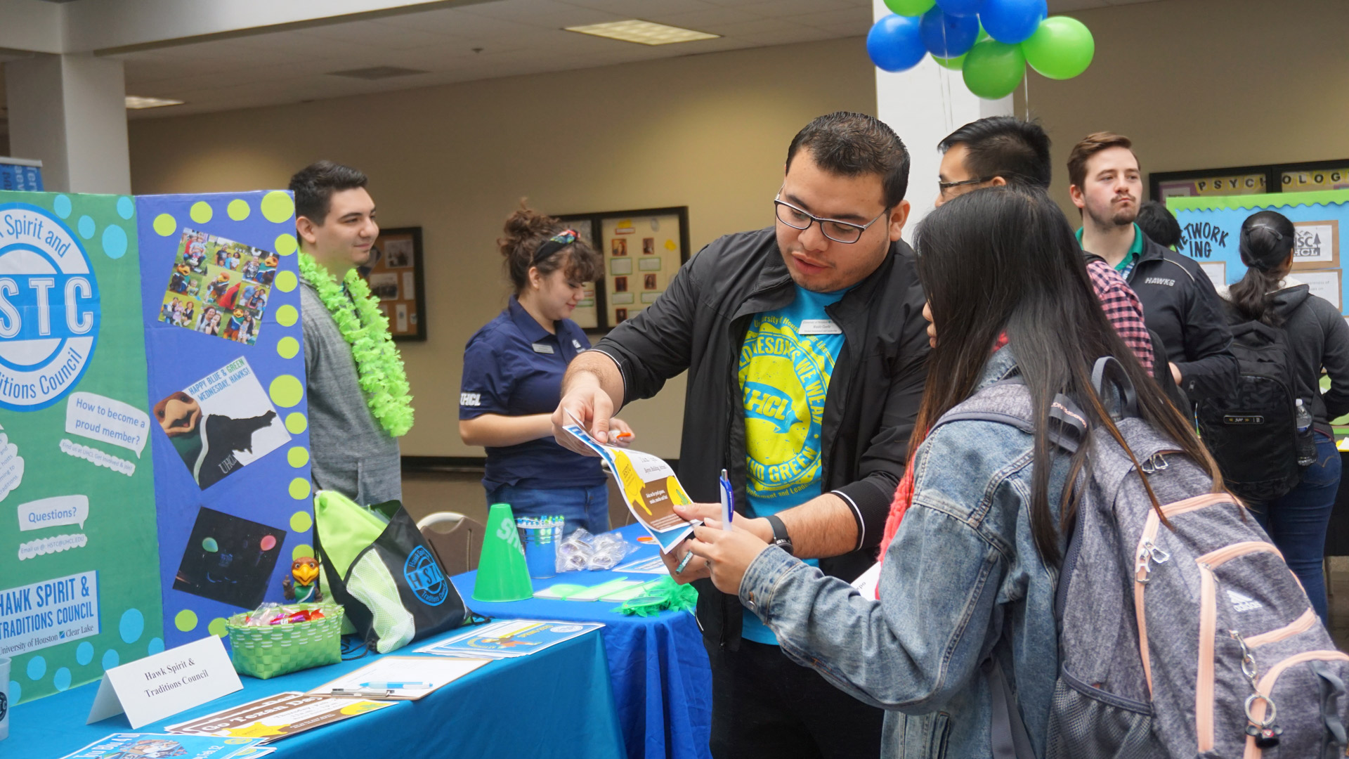 Students gathered at information tables during Spirit Week