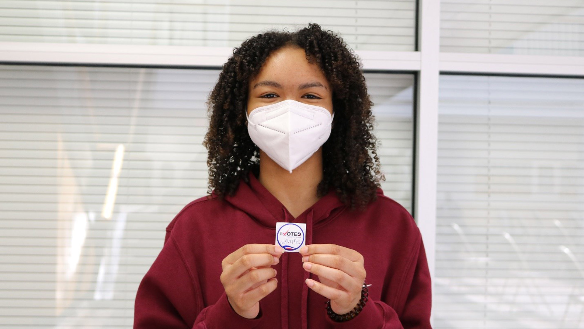 Student displaying I Voted sticker