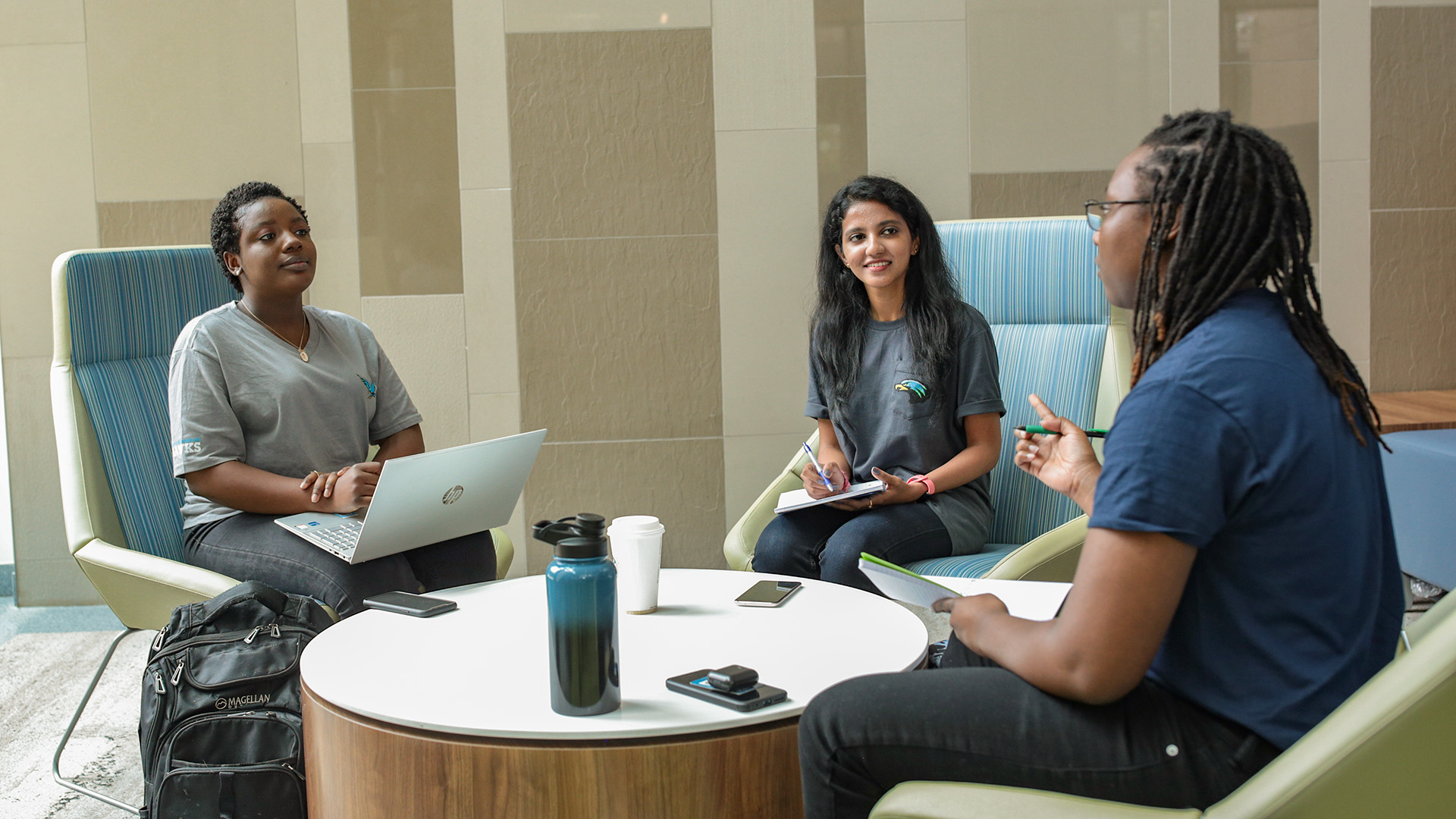 Students speaking in a small group on campus