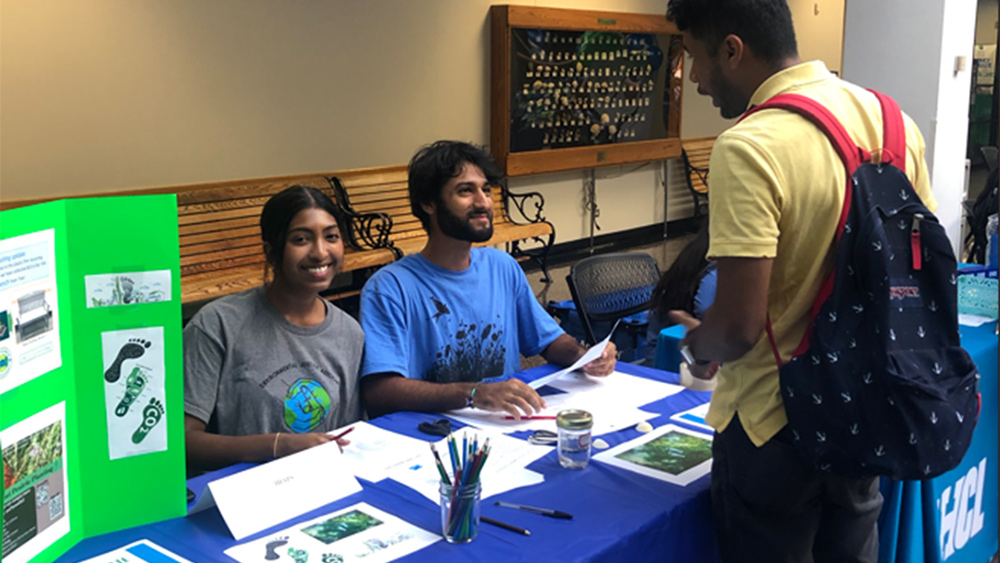 Faisal Syed pictured with two student ECO Committee members